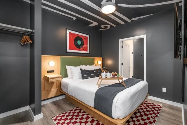 a dining room with furniture and a floor to ceiling window