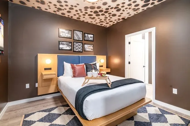 a large kitchen with stainless steel appliances kitchen island granite countertop a refrigerator and a sink