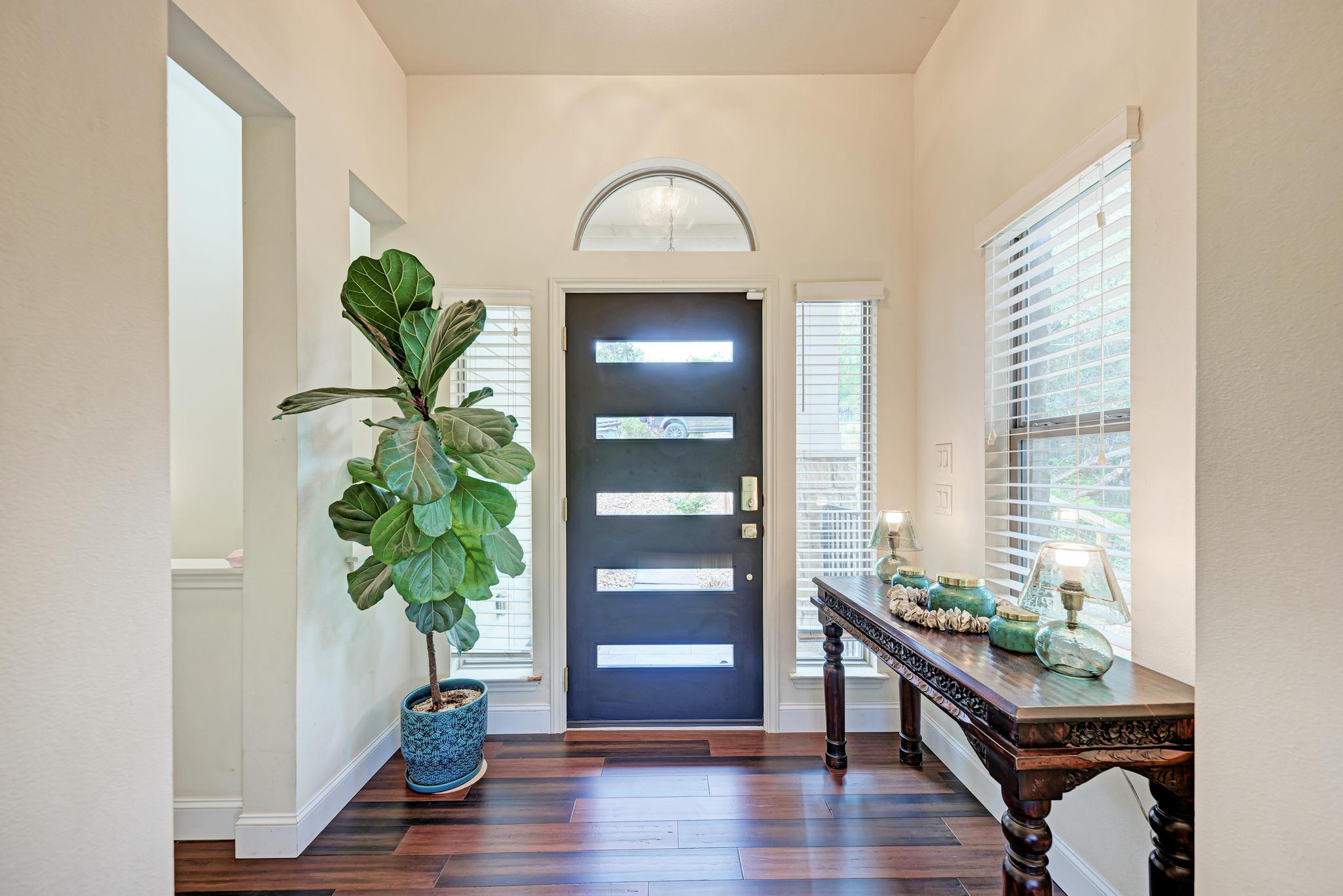 2605 Indian Creek Road Austin, TX 78734 - Photo 2 of 33 Entryway featuring dark wood-finish flooring, a modern door with horizontal glass inserts, and an arched transom window