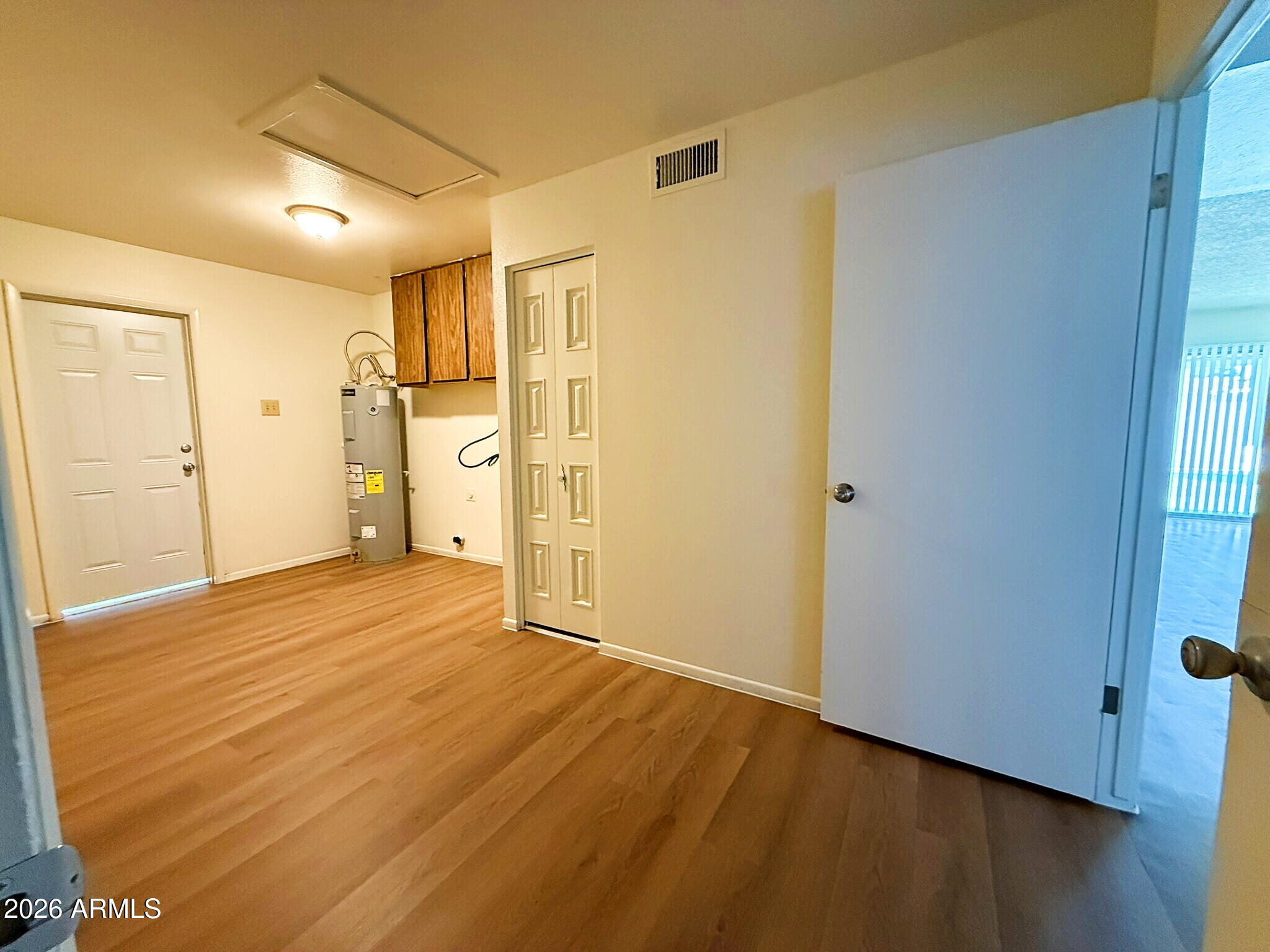 5208 West Calavar Road Glendale, AZ 85306 - Photo 38 of 39 a view of empty room with wooden floor and window