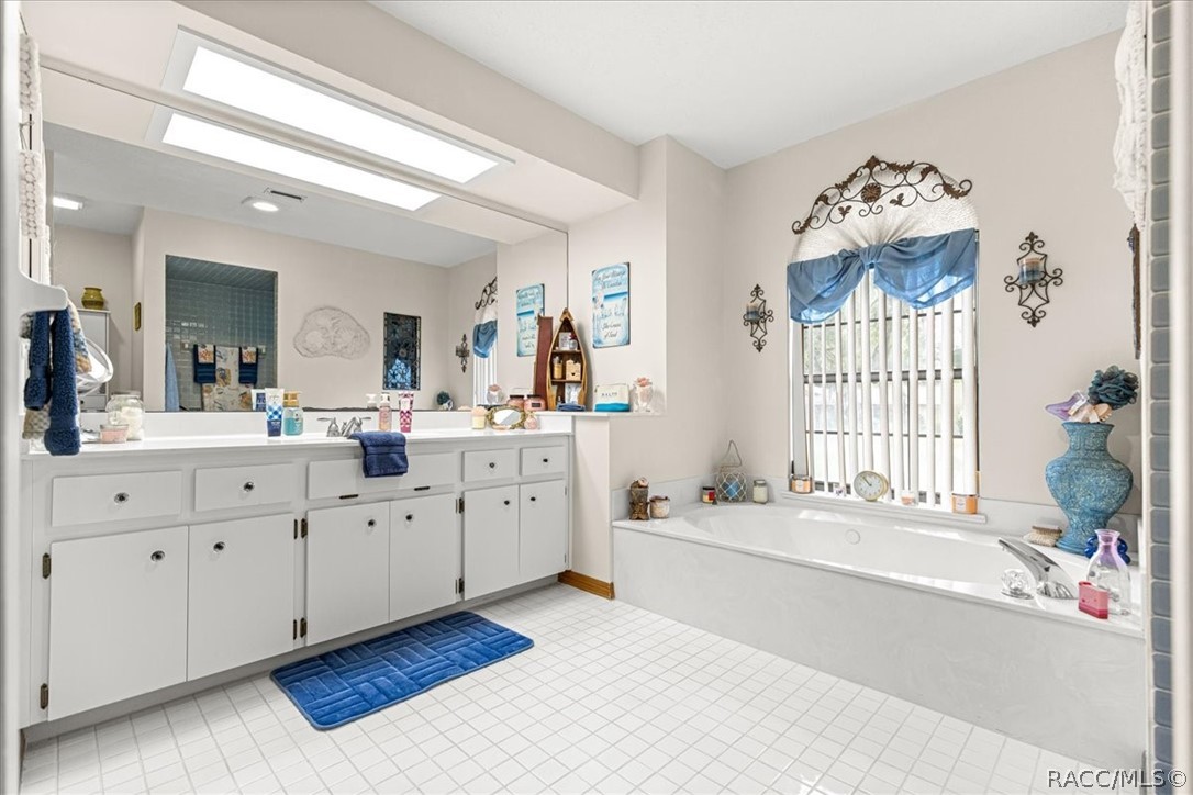 2964 South Cygnet Terrace Inverness, FL 34450 - Photo 25 of 67 a spacious en suite bathroom with a large tub mirror and window