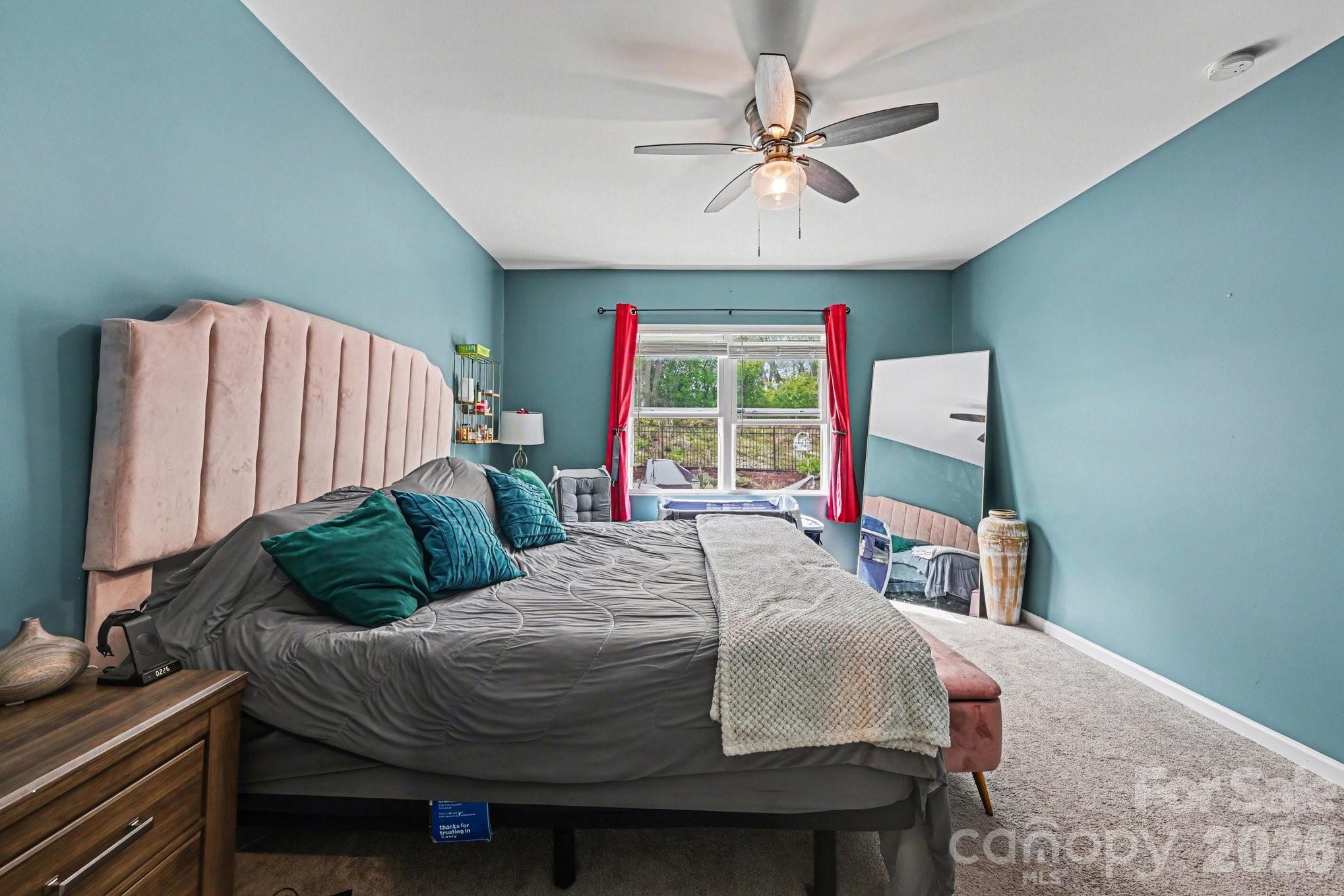 1235 Nesters Store Place Southwest Concord, NC 28027 - Photo 13 of 21 a bedroom with a bed a window and a flat screen tv
