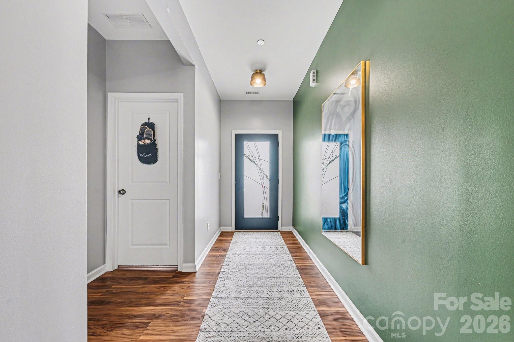 1235 Nesters Store Place Southwest Concord, NC 28027 - Photo 3 of 21 a view of a hallway with wooden floor and a bathroom