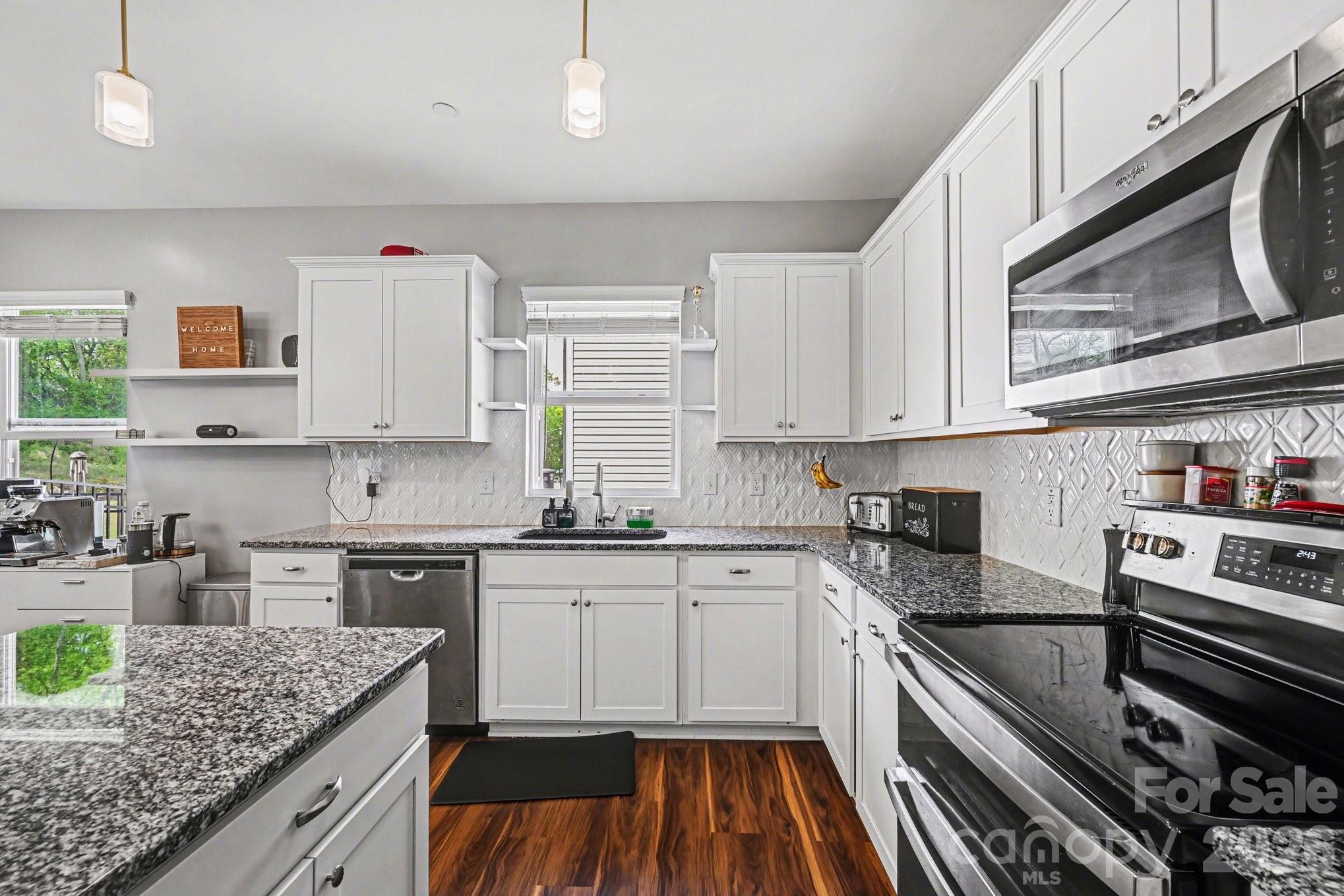 1235 Nesters Store Place Southwest Concord, NC 28027 - Photo 5 of 21 a kitchen with stainless steel appliances granite countertop a stove sink and cabinets