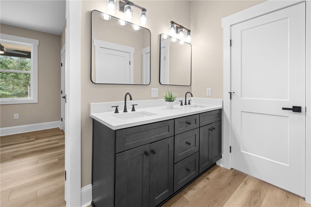 147 McAlister Road West Union, SC 29696 - Photo 27 of 50 Clean lines and dual sinks define this elegant bathroom vanity with stone counters.