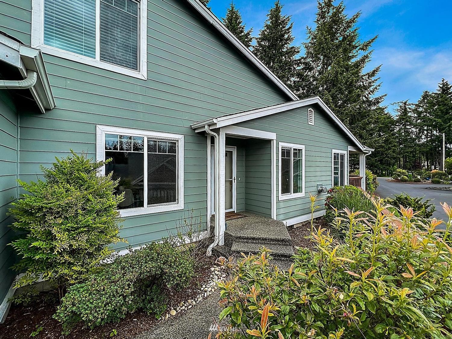 91 East Soderberg Road, Unit E14 Allyn, WA 98524 - Photo 1 of 40 a backyard of a house with seating space