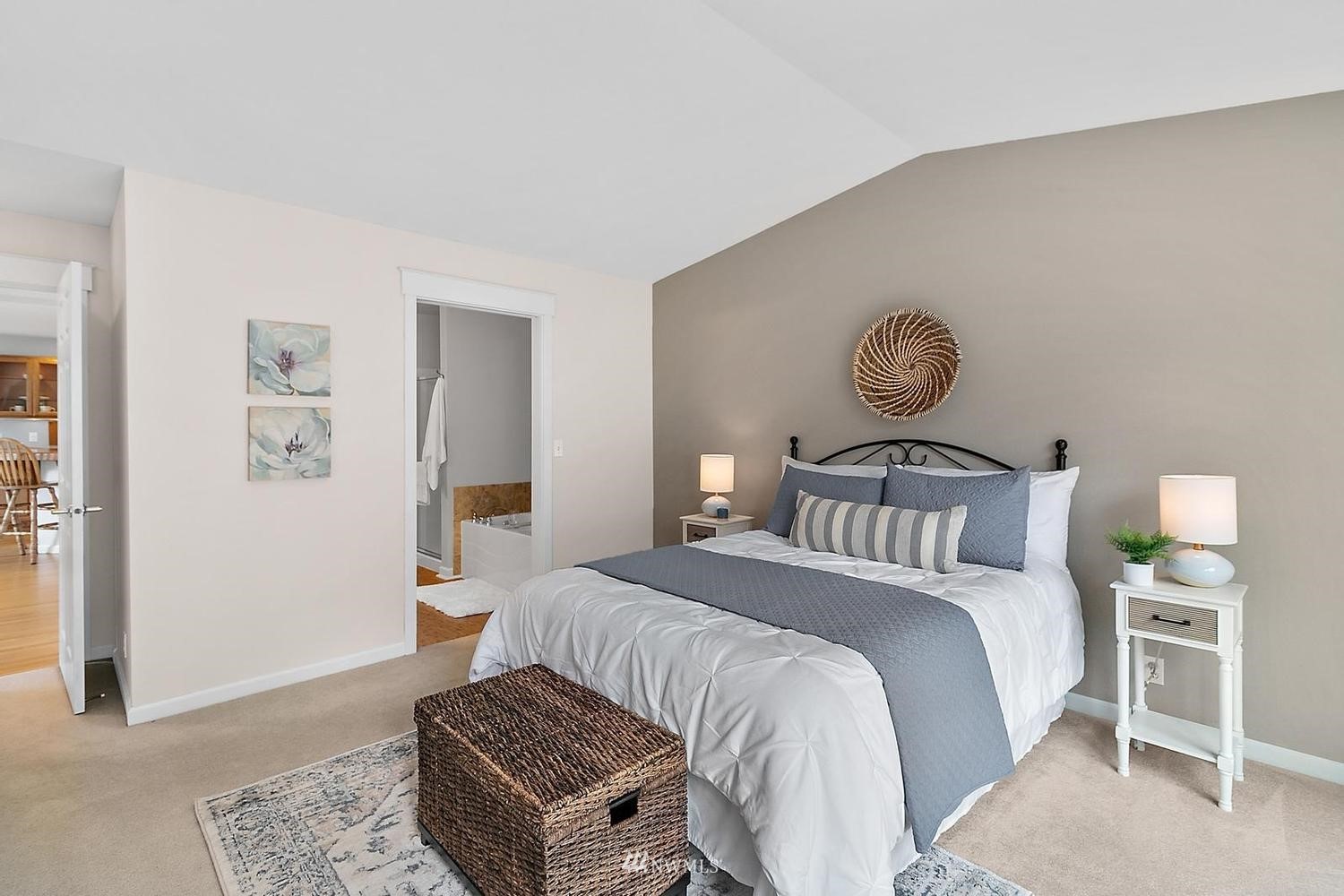 91 East Soderberg Road, Unit E14 Allyn, WA 98524 - Photo 16 of 40 a bedroom with a bed and a chandelier