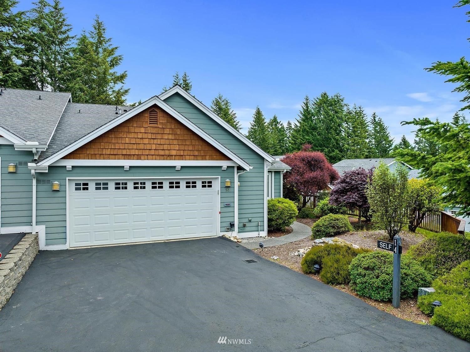 91 East Soderberg Road, Unit E14 Allyn, WA 98524 - Photo 34 of 40 a view of a house with a yard and potted plants