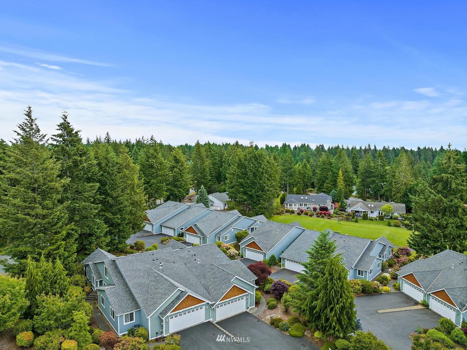 91 East Soderberg Road, Unit E14 Allyn, WA 98524 - Photo 35 of 40 an aerial view of a house with swimming pool a yard and lake view