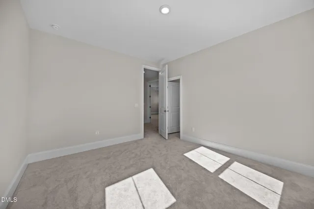 a view of an empty room and wooden floor