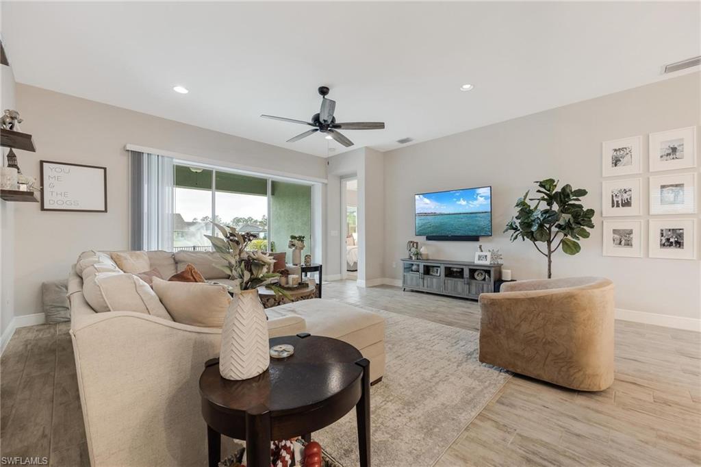 3621 Pilot Circle Naples, FL 34120 - Photo 24 of 46 a living room with furniture a chandelier and a flat screen tv