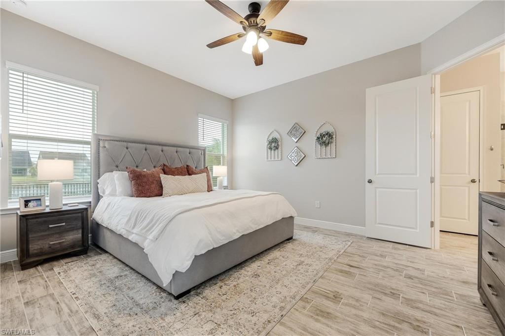 3621 Pilot Circle Naples, FL 34120 - Photo 25 of 46 a bedroom with a bed and a chandelier