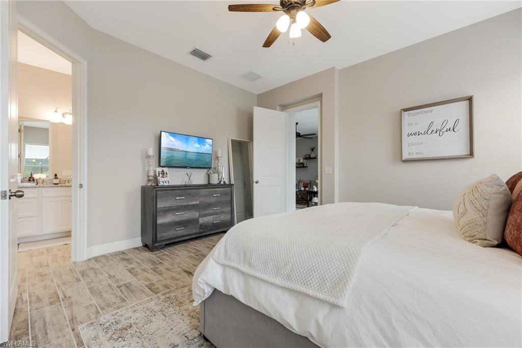 3621 Pilot Circle Naples, FL 34120 - Photo 26 of 46 a bedroom with a bed and a flat screen tv