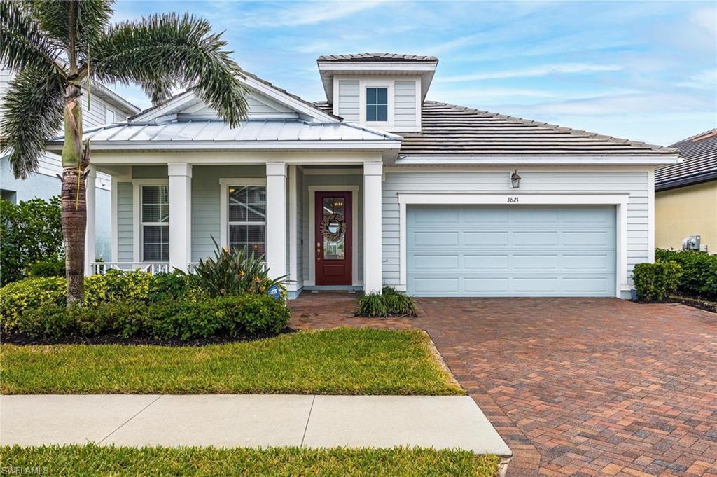 3621 Pilot Circle Naples, FL 34120 - Photo 46 of 46 a front view of a house with a garden and palm tree