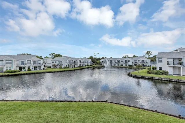 a view of a lake with houses in the back