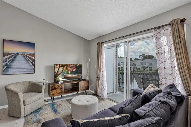 a living room with furniture and a floor to ceiling window