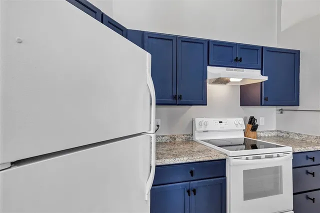 a kitchen with stainless steel appliances a refrigerator and a stove top oven