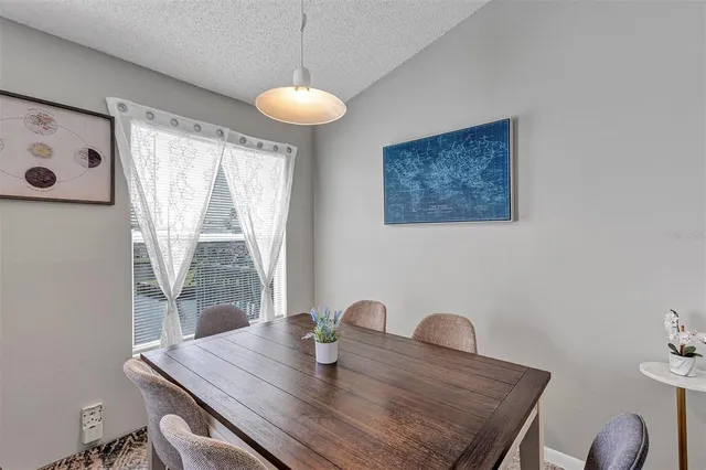 a view of a dining room with furniture and window