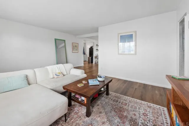 a view of a livingroom with furniture and wooden floor