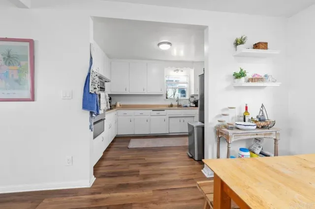 a kitchen with granite countertop a sink stainless steel appliances and cabinets