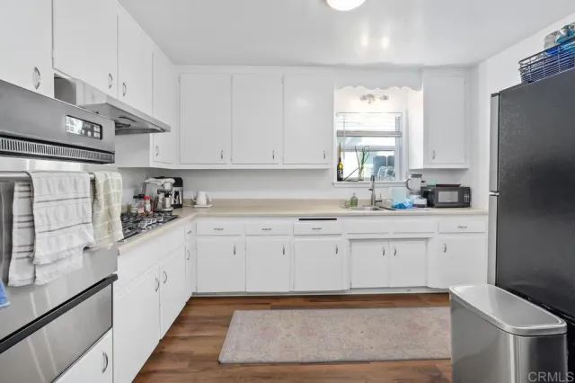 a kitchen with a sink and a refrigerator