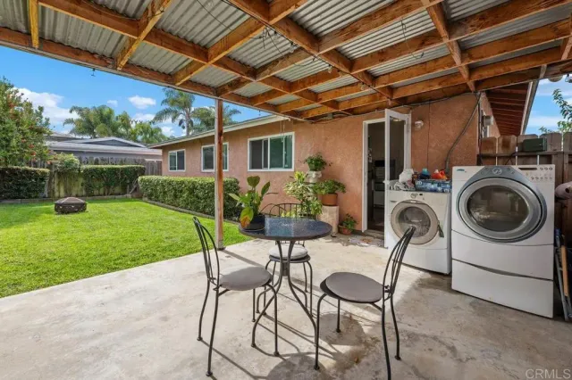 a view of a backyard with sitting area