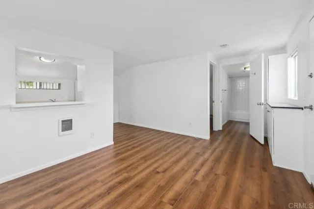 a kitchen with a refrigerator sink stove and white cabinets