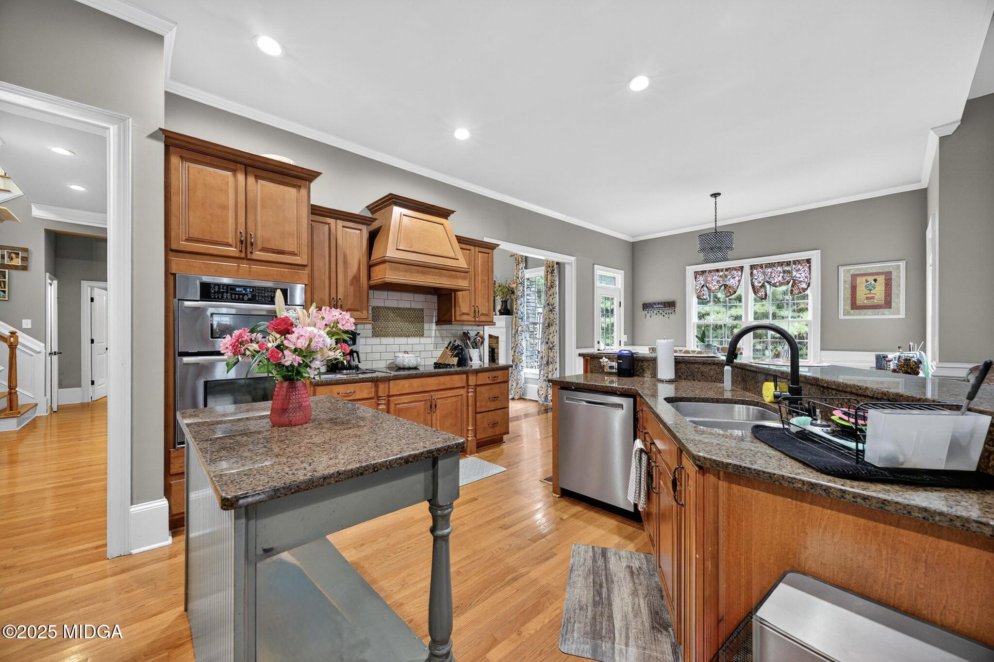 120 Homestead Circle Forsyth, GA 31029 - Photo 12 of 68 a kitchen with stainless steel appliances granite countertop sink stove top oven and cabinets
