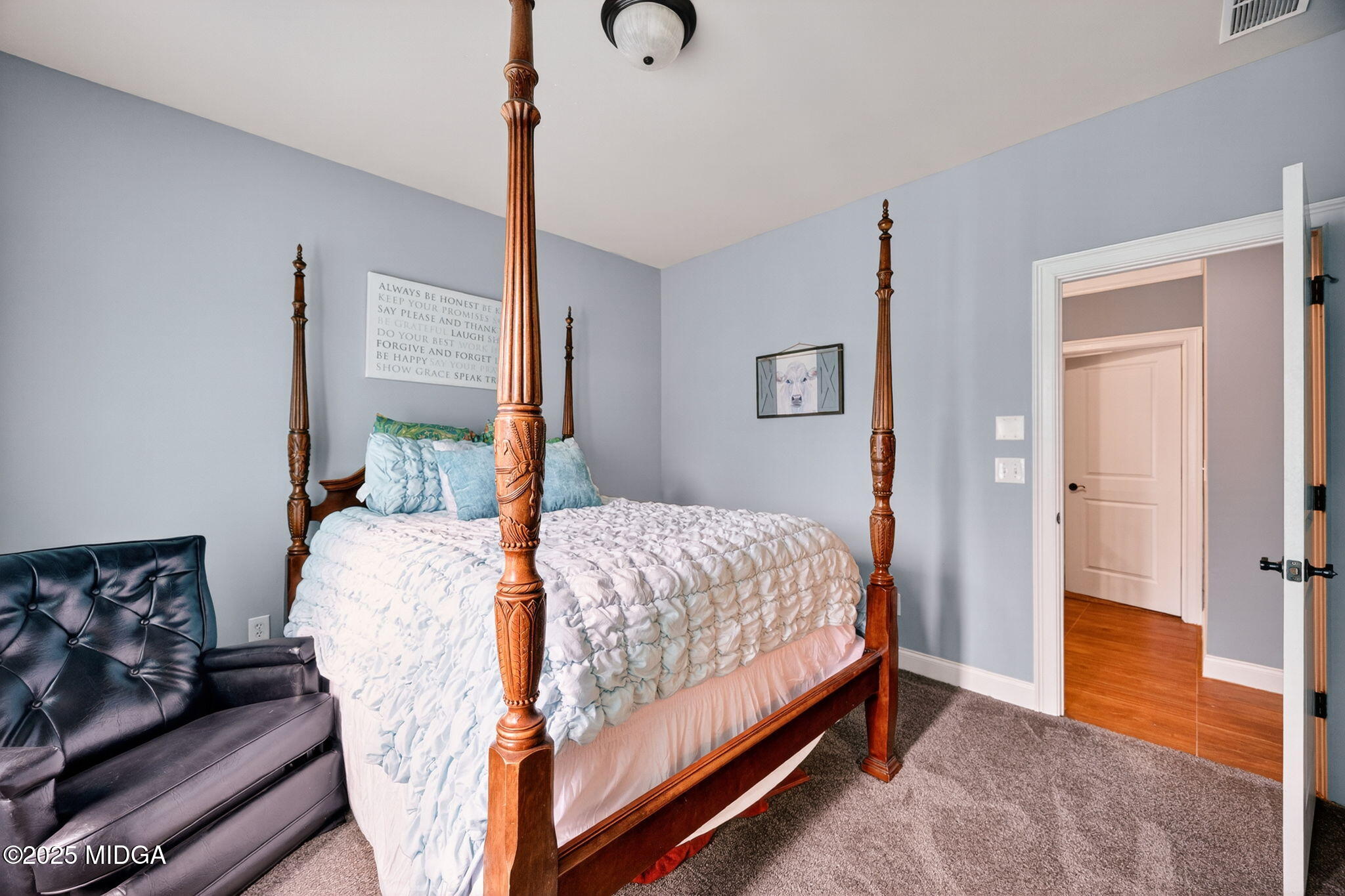 120 Homestead Circle Forsyth, GA 31029 - Photo 27 of 68 a bedroom with a bed and wooden floor