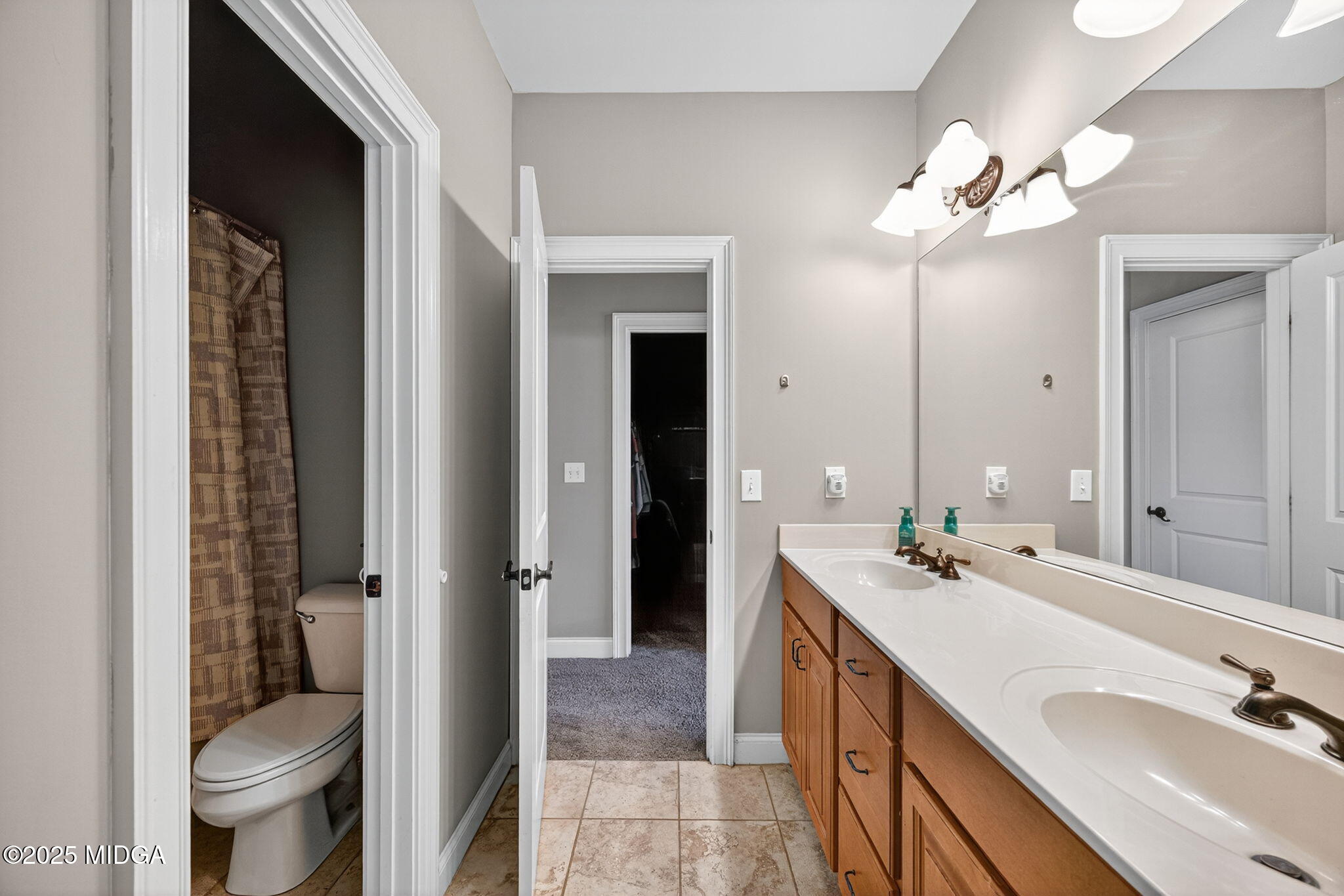 120 Homestead Circle Forsyth, GA 31029 - Photo 28 of 68 a spacious bathroom with a double vanity sink a toilet and a mirror