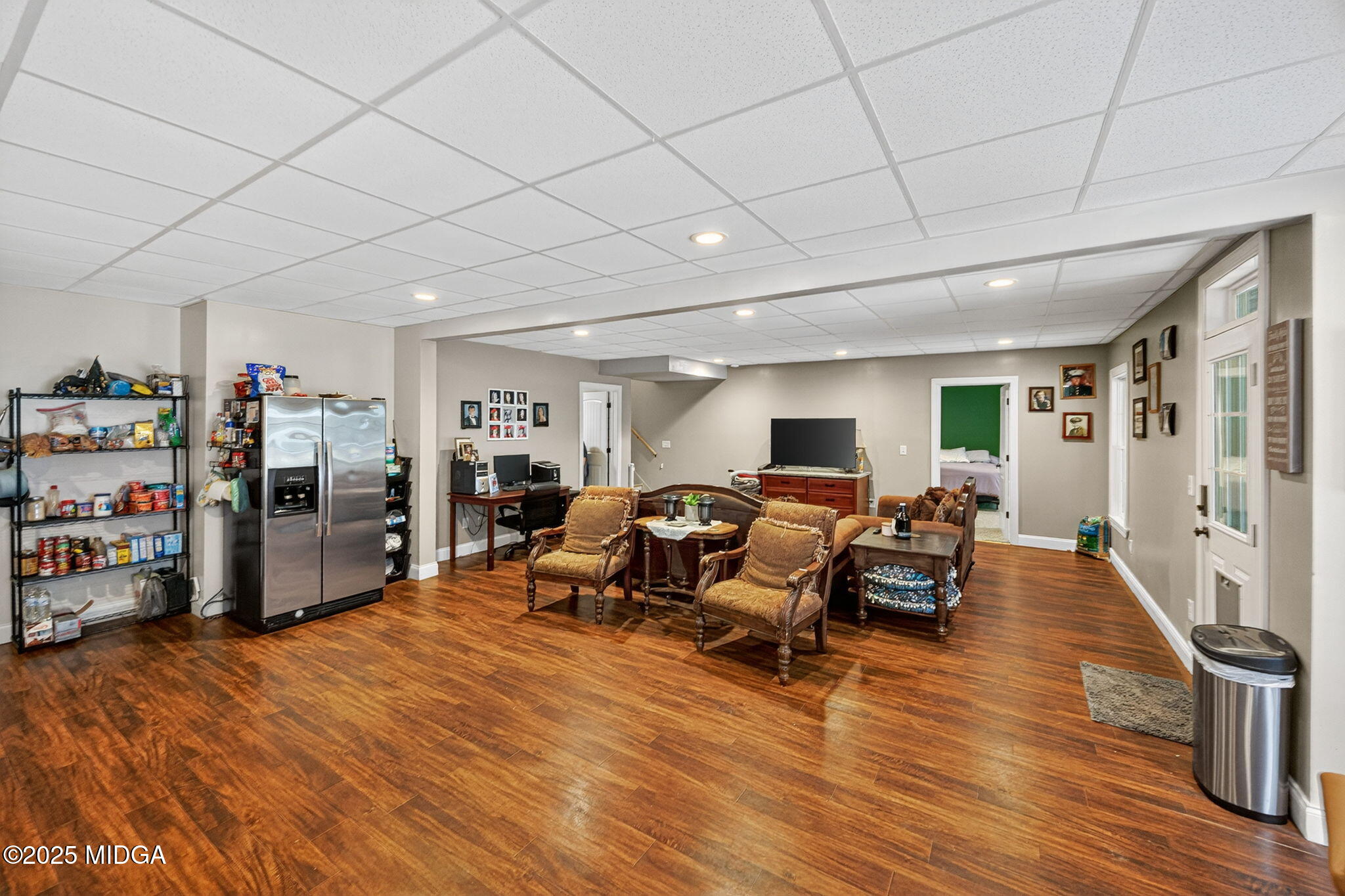 120 Homestead Circle Forsyth, GA 31029 - Photo 34 of 68 a living room with furniture and a wooden floor