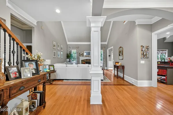 a living room with furniture a rug and a large window