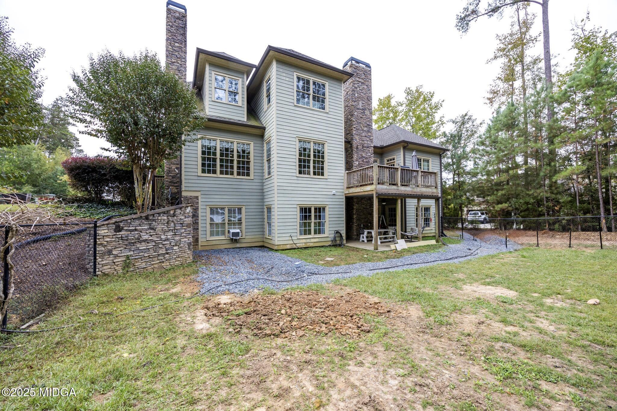 120 Homestead Circle Forsyth, GA 31029 - Photo 45 of 68 a view of a house with a big yard and large trees