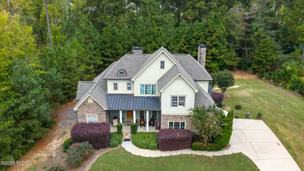 an aerial view of residential house with outdoor space and swimming pool