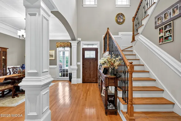 a view of entryway livingroom and hall with wooden floor