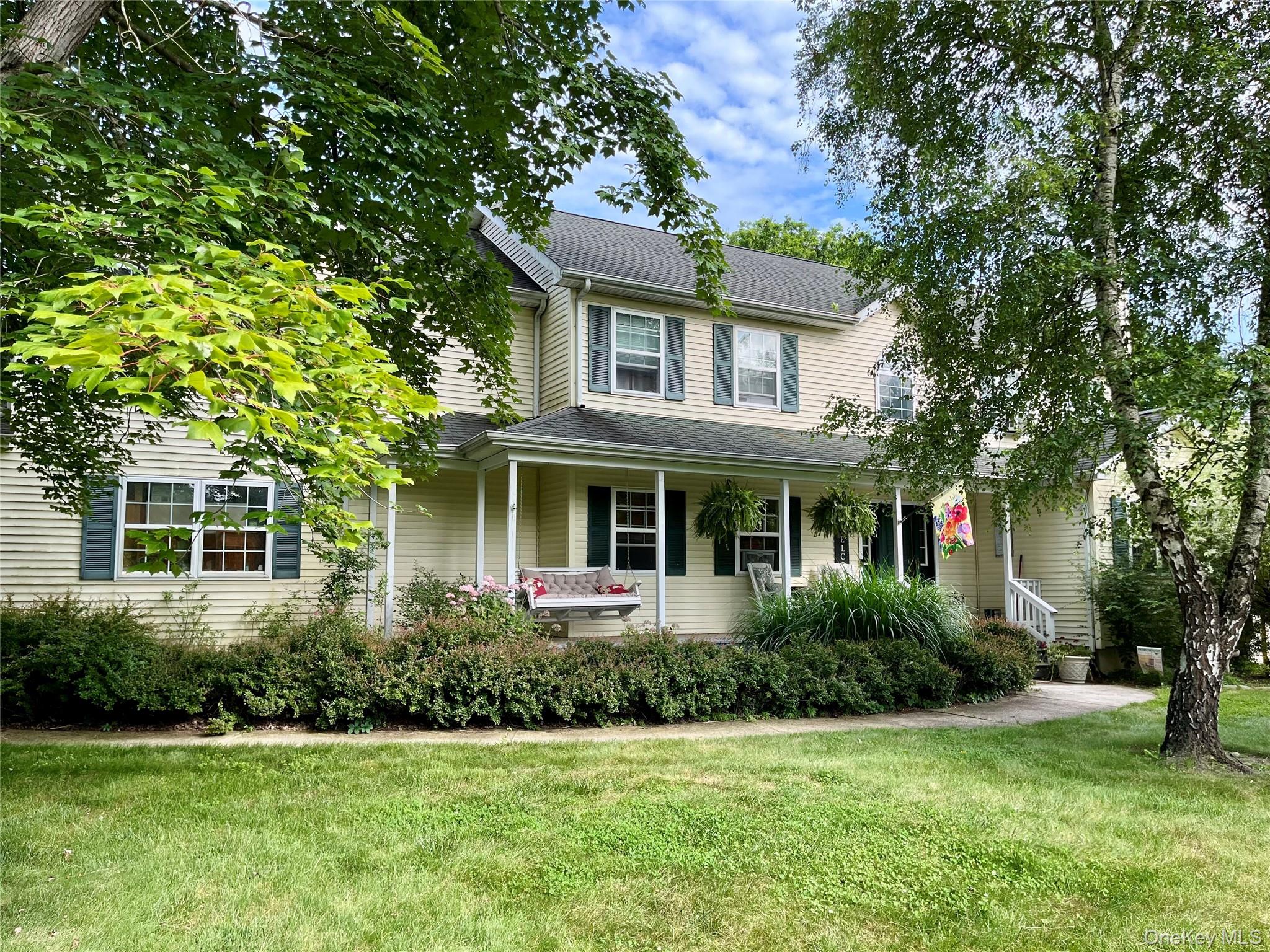 124 Rutsonville Road Wallkill, NY 12589 - Photo 17 of 33 Two-story residence featuring light-toned siding, a covered front porch with white columns, and dark green louvered shutters