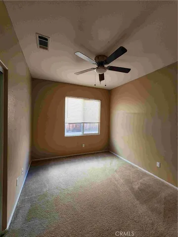 an empty room with a empty space and a ceiling fan