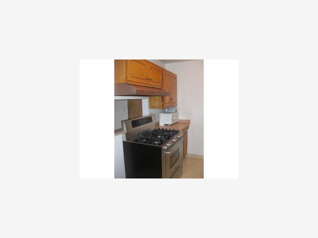 832 Standish Road Pacifica, CA 94044 - Photo 7 of 9 a kitchen with a stove and a refrigerator