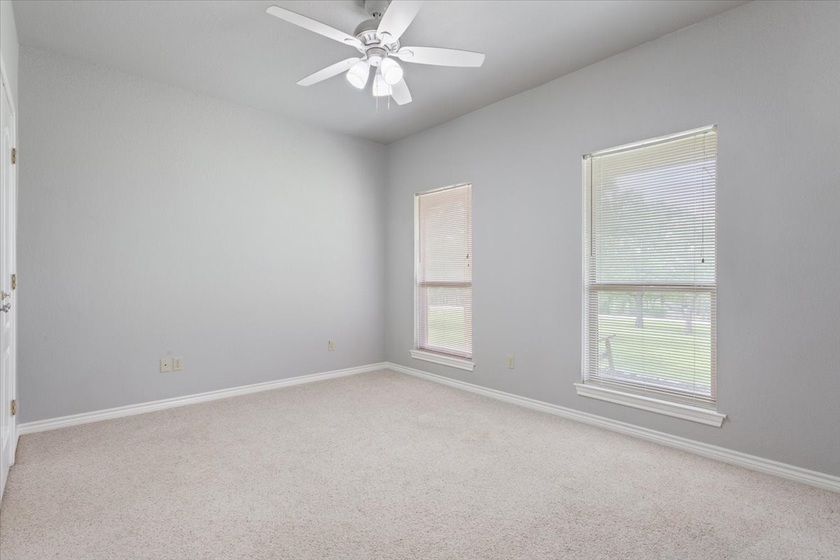 140 Oak Ridge Loop Whitney, TX 76692 - Photo 28 of 40 an empty room with windows and fan