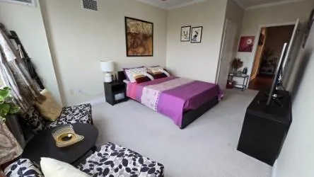 a bedroom with furniture and a window