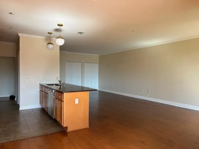 a kitchen with granite countertop a stove and a sink