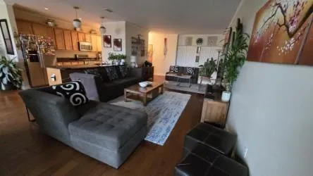 a living room with furniture and a chandelier