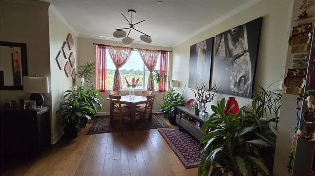 a living room with furniture or chandelier and a wooden floor