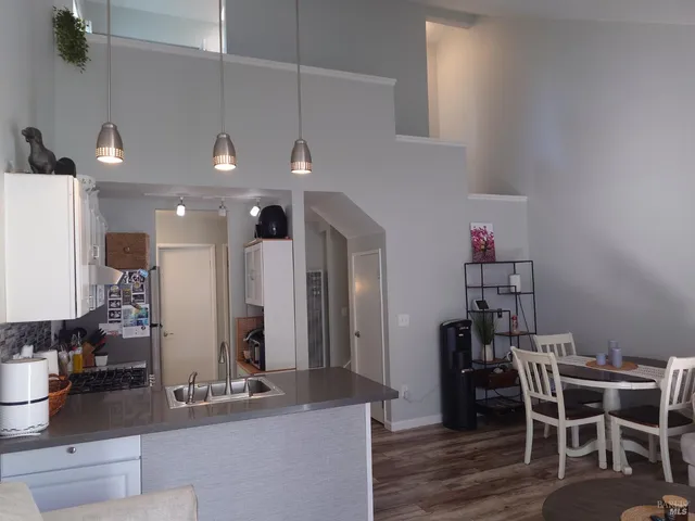 a dining room with furniture and wooden floor