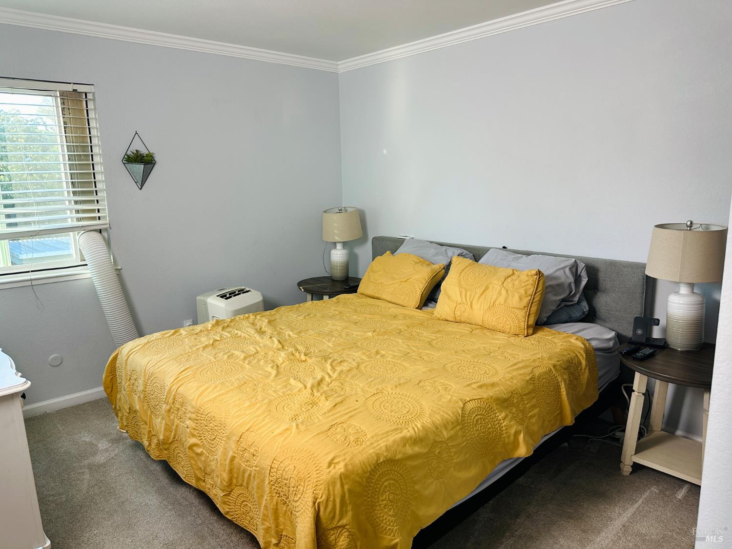 172 Courtyards East Windsor, CA 95492 - Photo 7 of 15 a large bed sitting in a bedroom next to a window and wooden floor