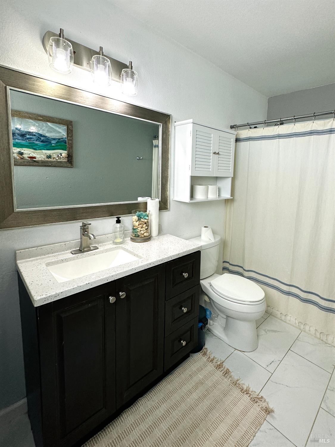 172 Courtyards East Windsor, CA 95492 - Photo 9 of 15 a bathroom with a toilet sink and mirror