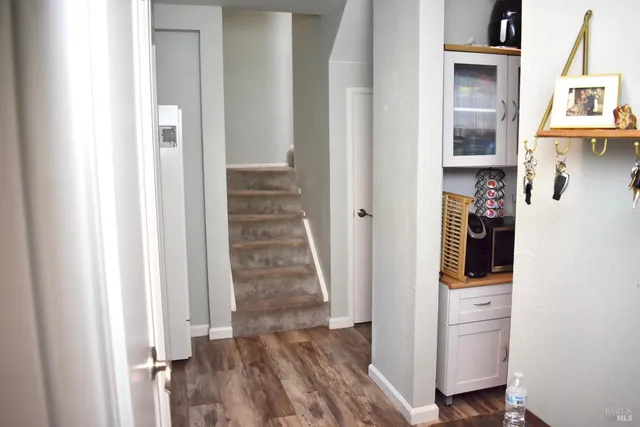 a view of a hallway with wooden floor and entryway