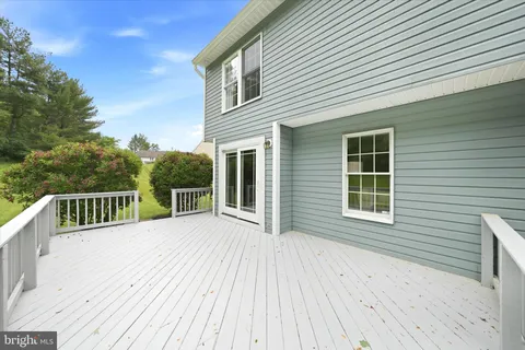 a view of a house with wooden deck