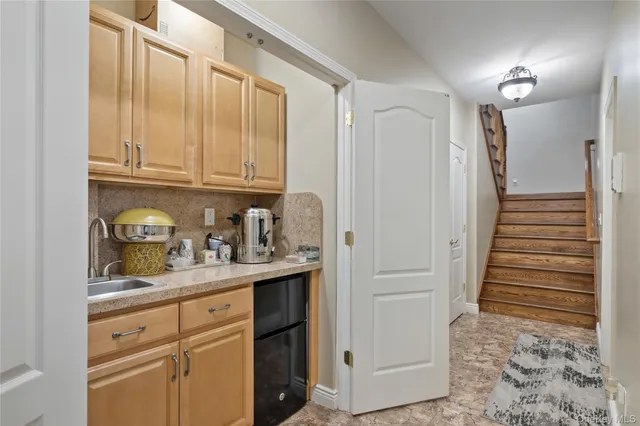 a kitchen with granite countertop a refrigerator and cabinets