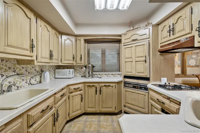 a kitchen with a sink stove and cabinets